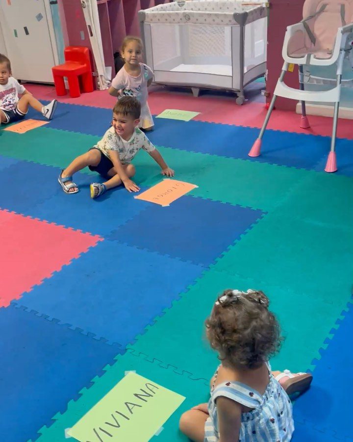 Children learning letters with alphabet cards at My Piccolo Mondo