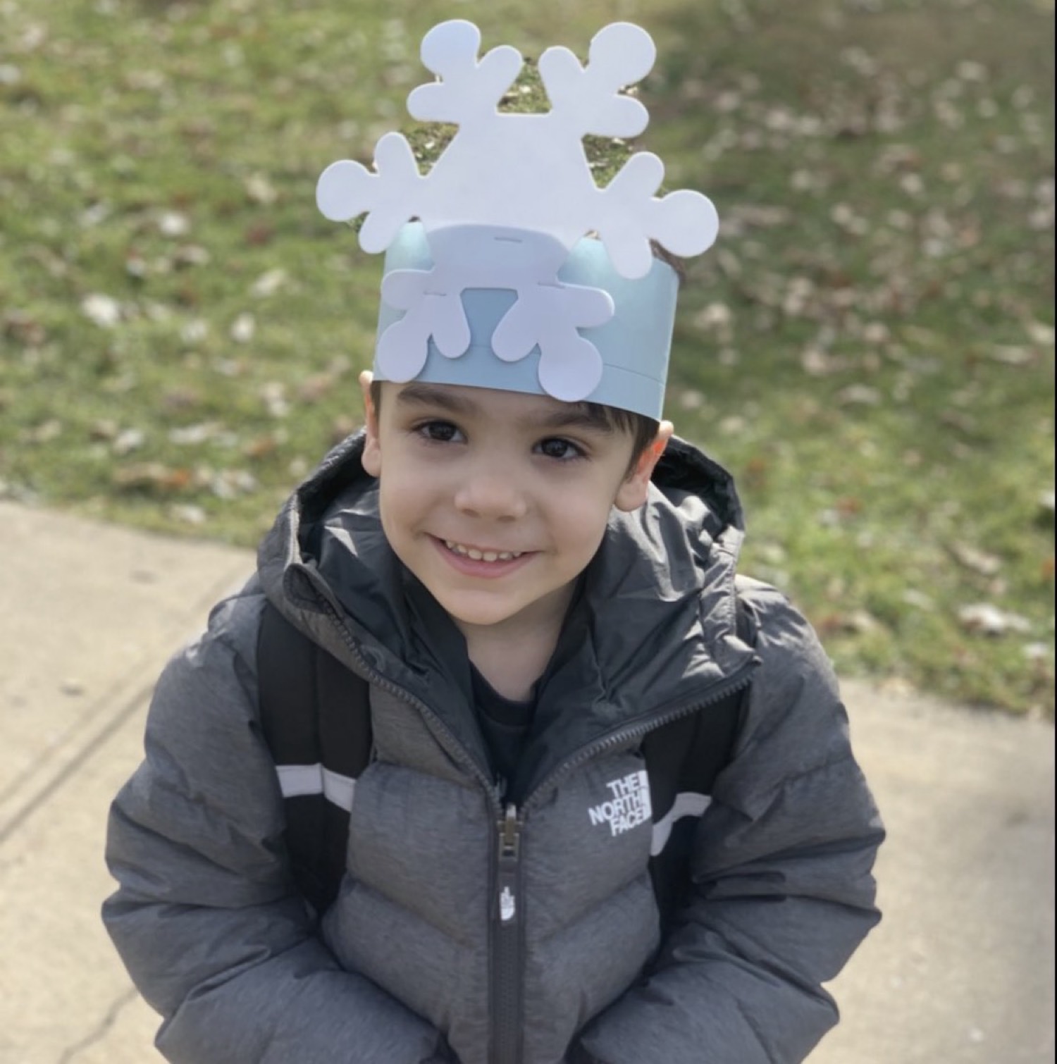 A child wearing a handmade snowflake crown