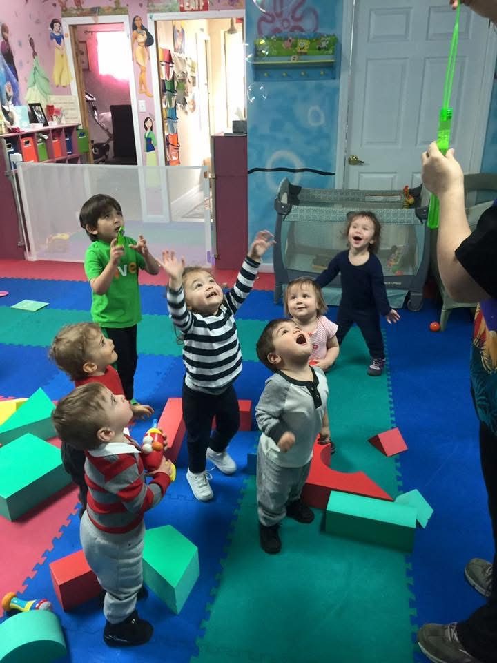 Toddler exploring colorful shape and stacking toys