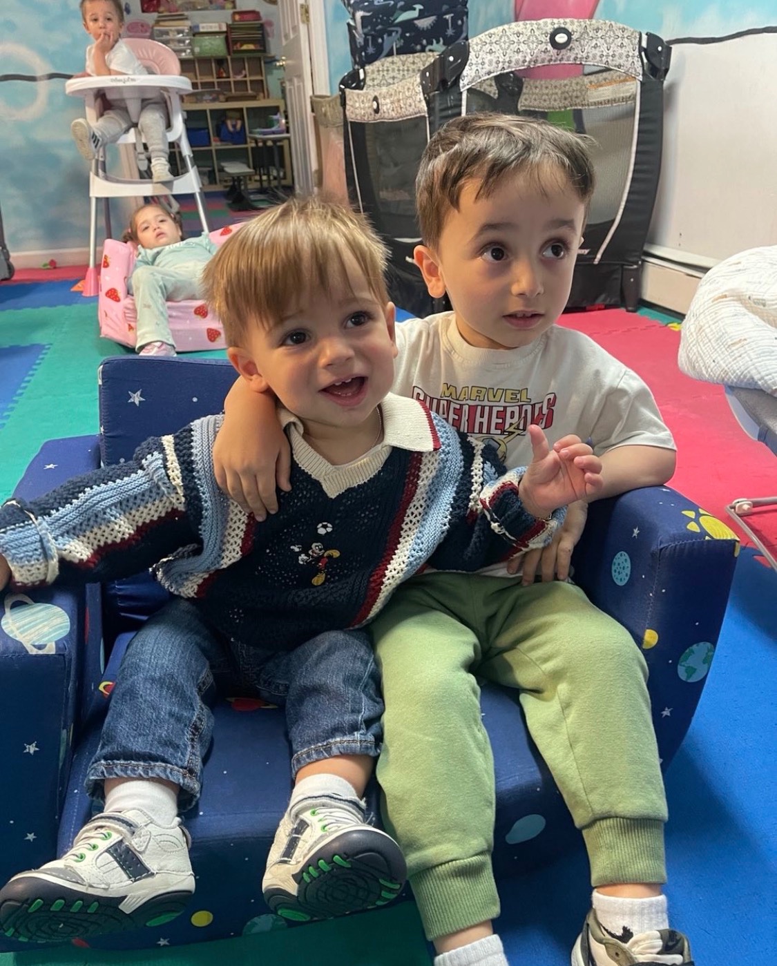Two children building with colorful foam blocks at My Piccolo Mondo